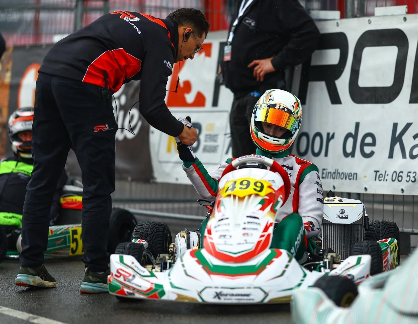 Team coach and driver on the grid